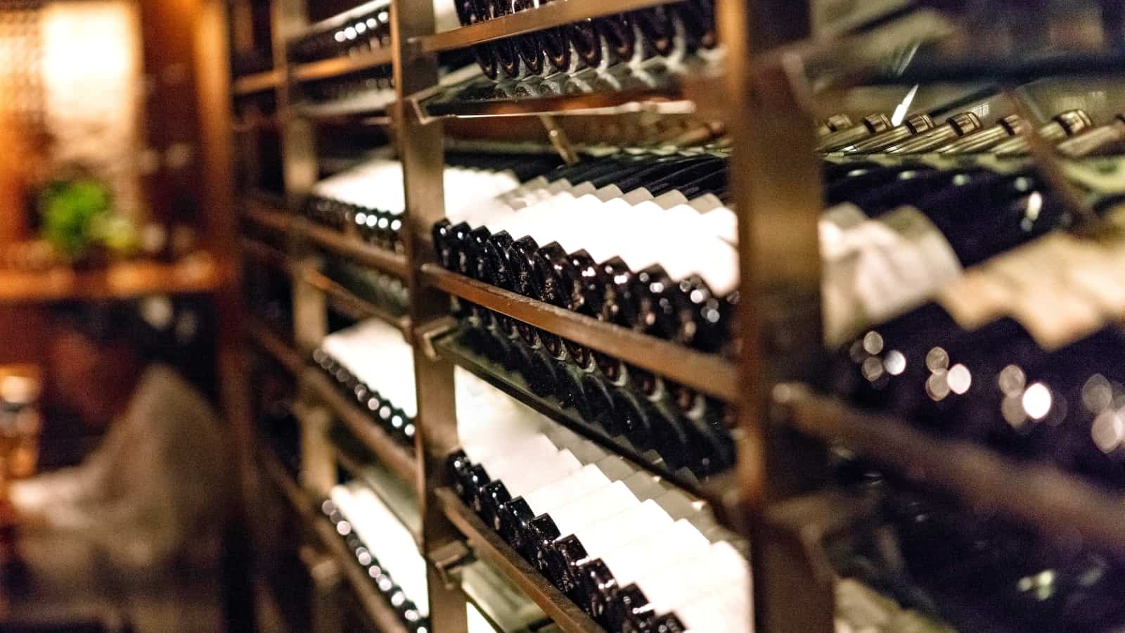 rack in a wine cellar with various bottles of wine