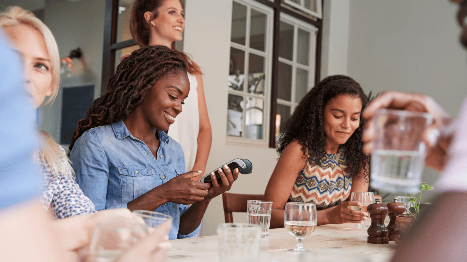 Friends Paying at Restaurant