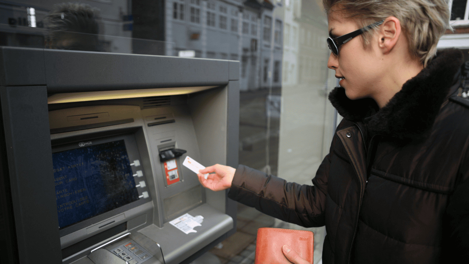 Data at Risk: 11 Travel Habits That Threaten Your Cybersecurity 7 Woman Using ATM