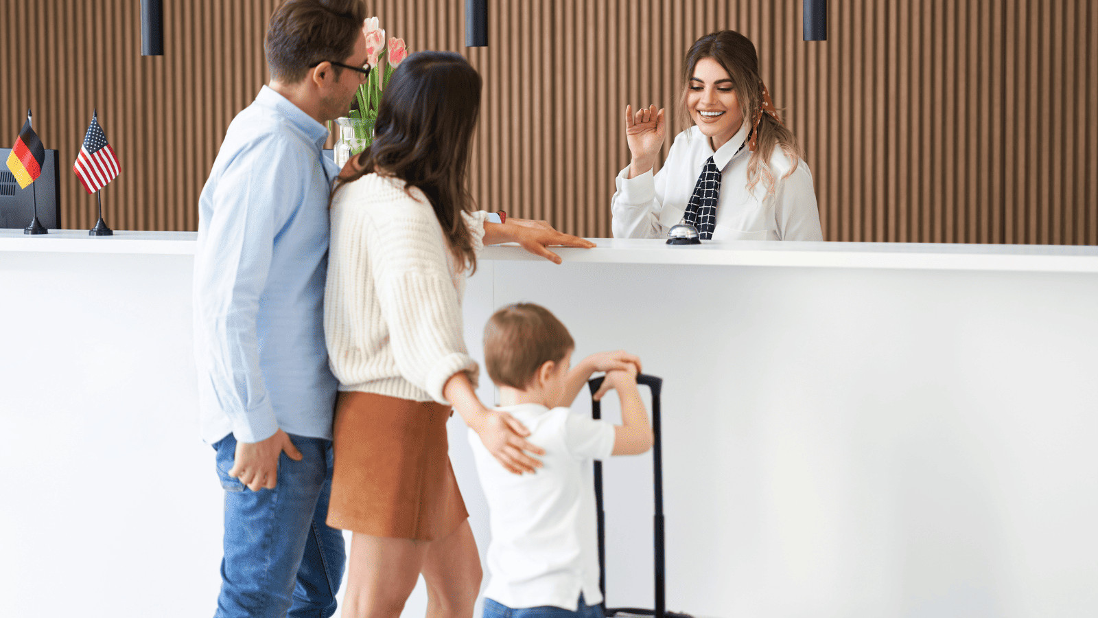 Family Travel Made Easy: Top Tips for Traveling With Kids 3 Family Checking Into Hotel
