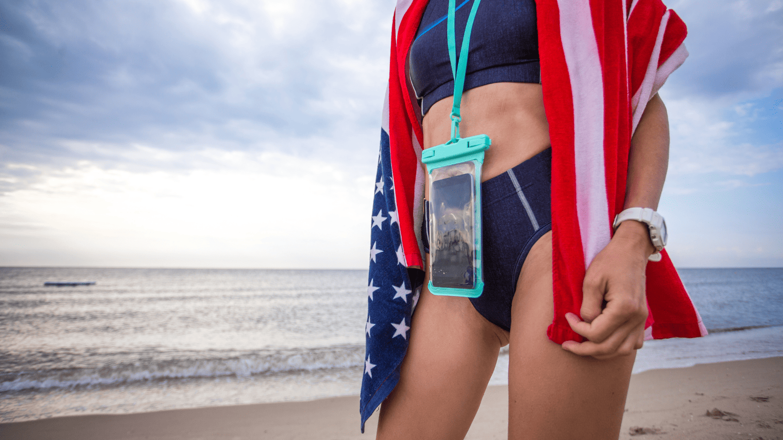 Woman with waterproof phone case on beach