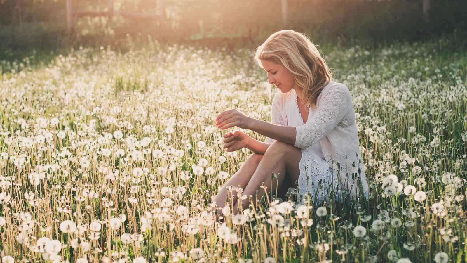 Woman Sitting In A Meadow