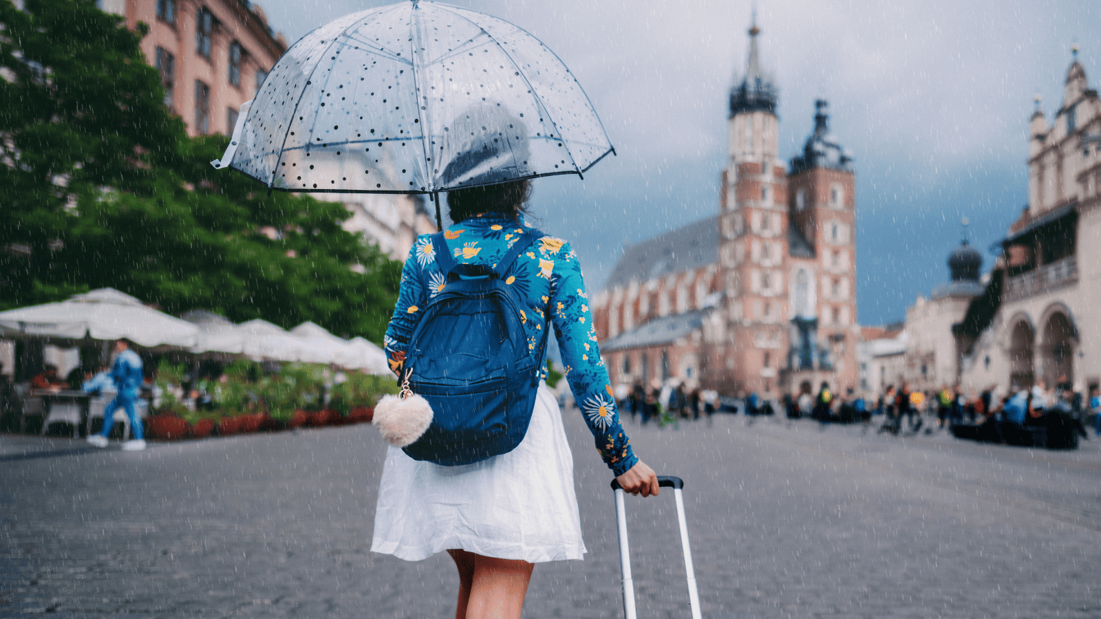 Woman holding umbrella while traveling