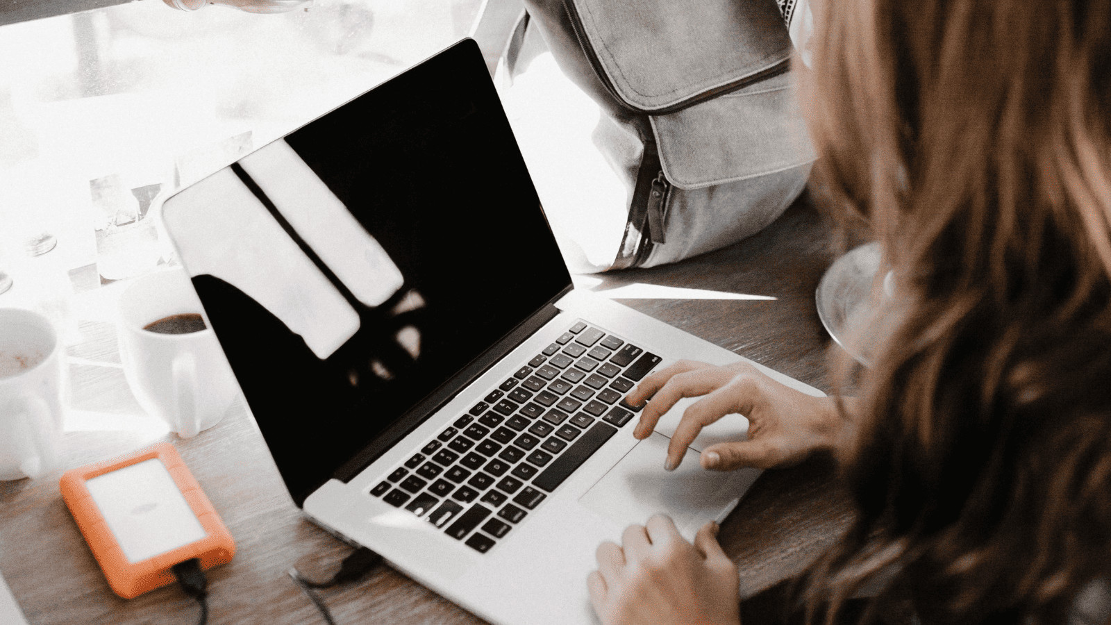 Data at Risk: 11 Travel Habits That Threaten Your Cybersecurity 11 woman using laptop