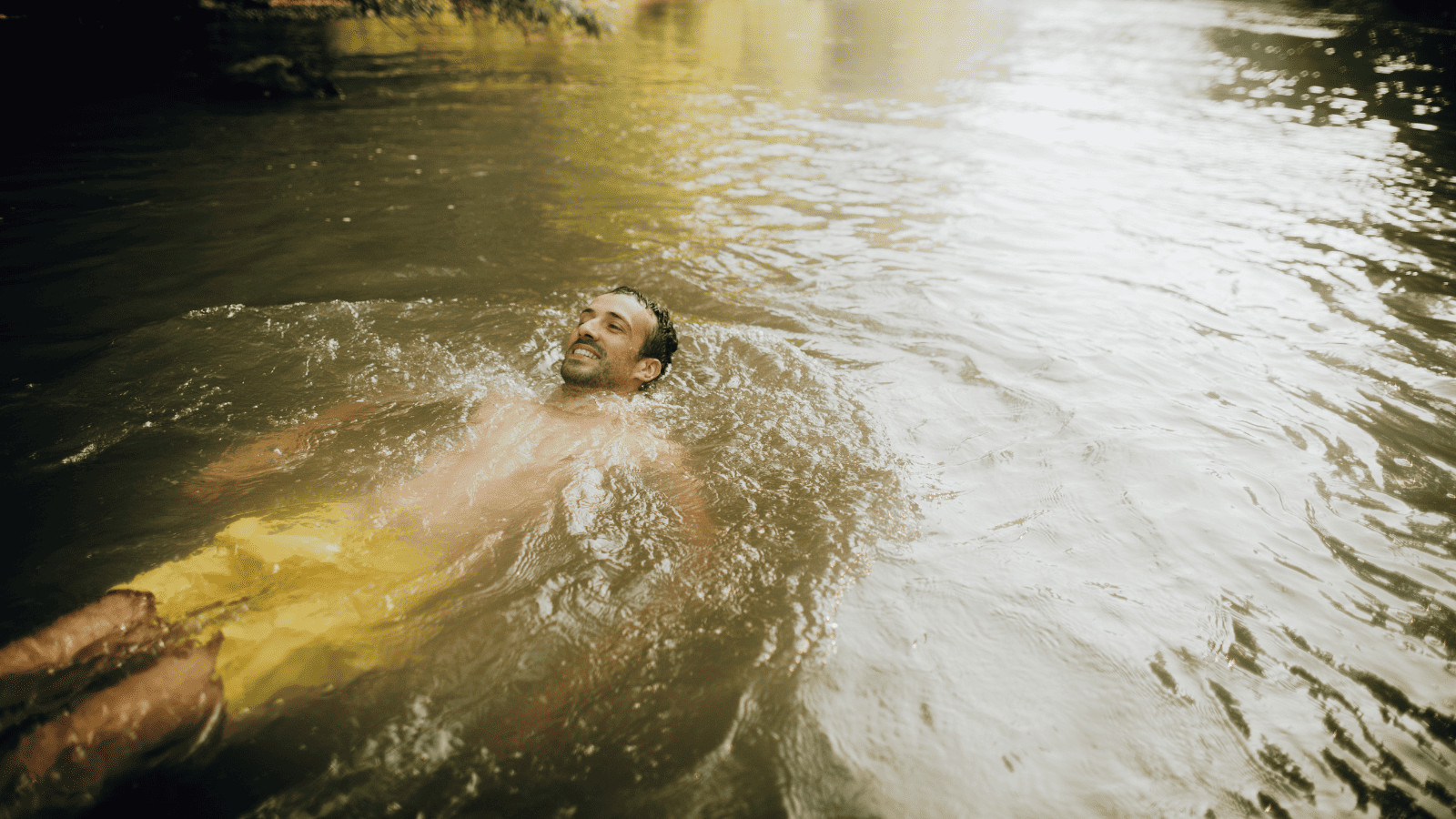 man relaxing in lake