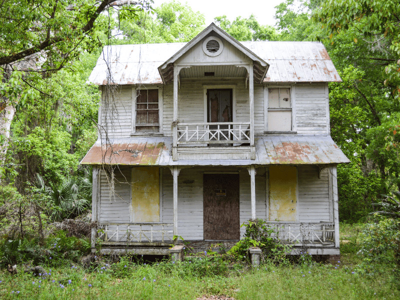 "Finding Beauty in Desolation": A Deep Dive into 12 Ghost Towns in Kansas 8 Abandoned home in woods
