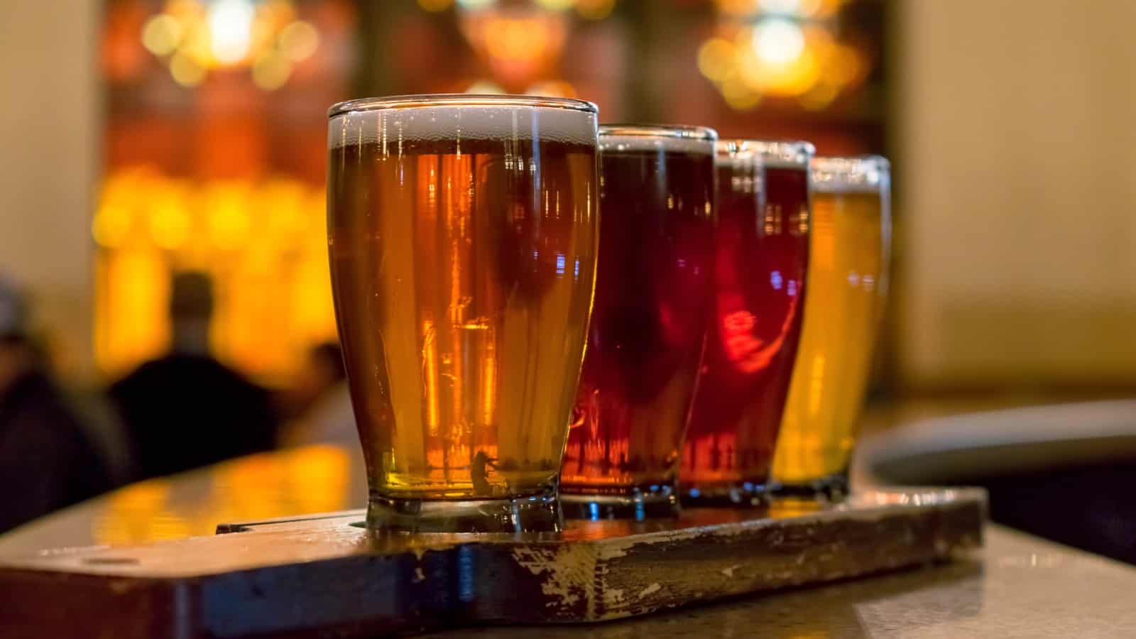 Closeup of craft beer flight on rustic paddle