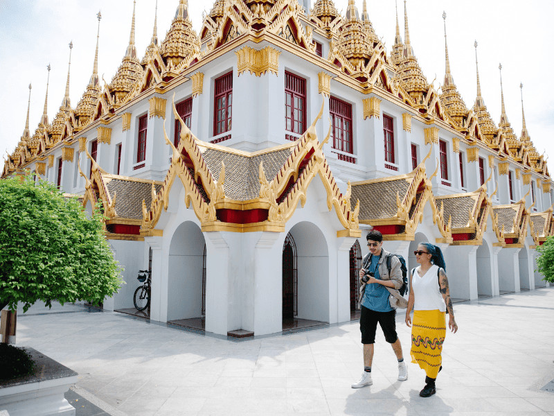 12 Ways to Spot an American Tourist Abroad – How Many Are You Guilty Of? 11 Couple walking by a temple