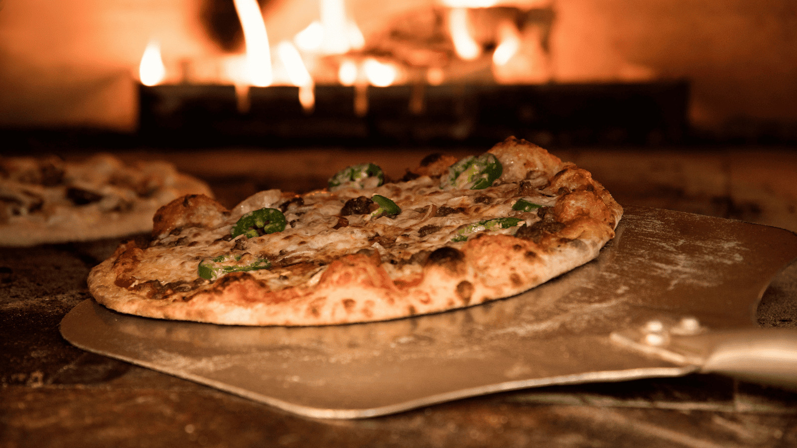 Flavortown Maryland: 11 Diners, Drive-Ins, and Dives Spots You Must Try! 6 Pizza going into a pizza oven
