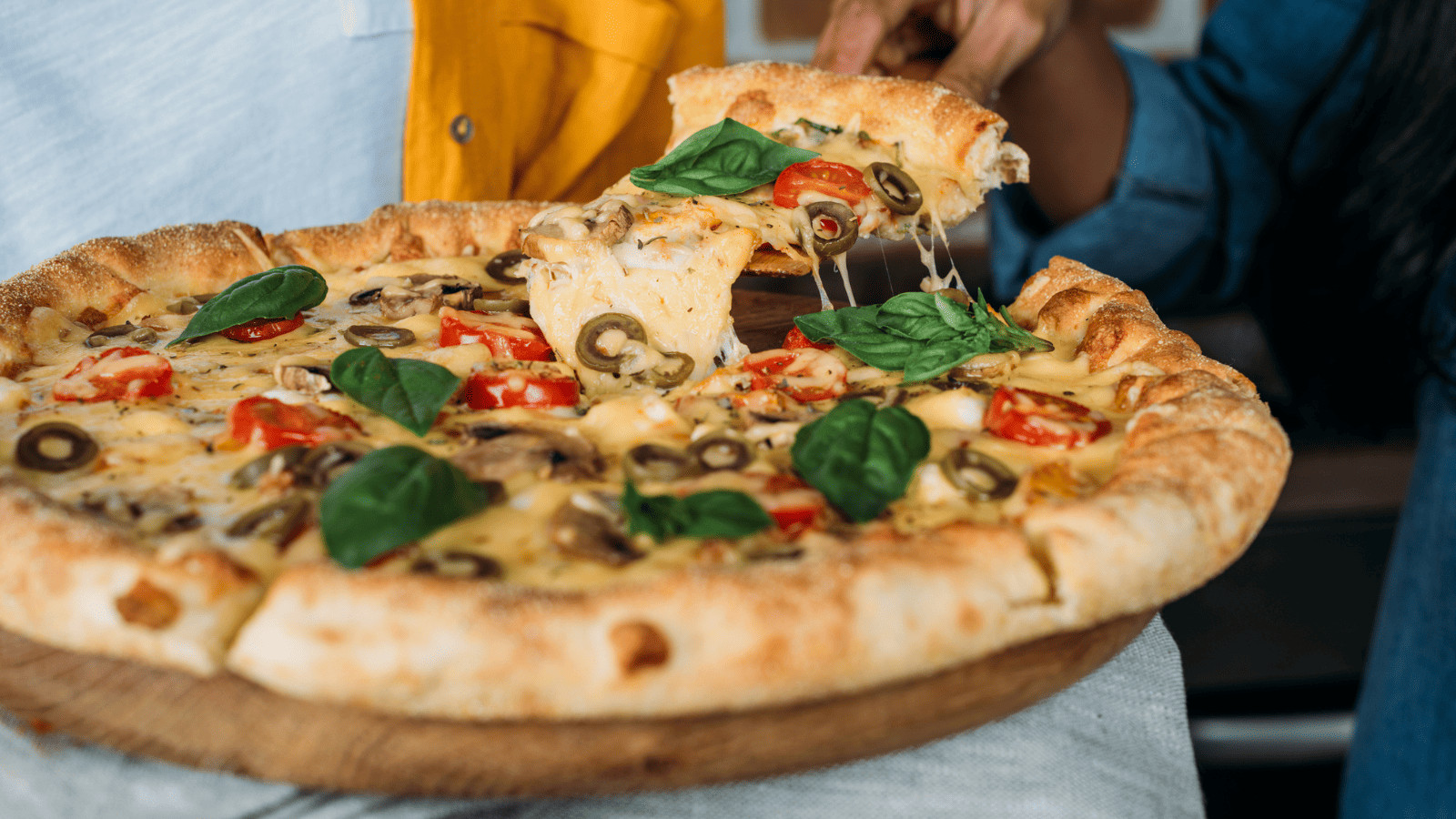 Hit the Jackpot with Guy Fieri: Nevada's 15 Winning Diners, Drive-Ins, and Dives! 6 Pizza slice being picked up