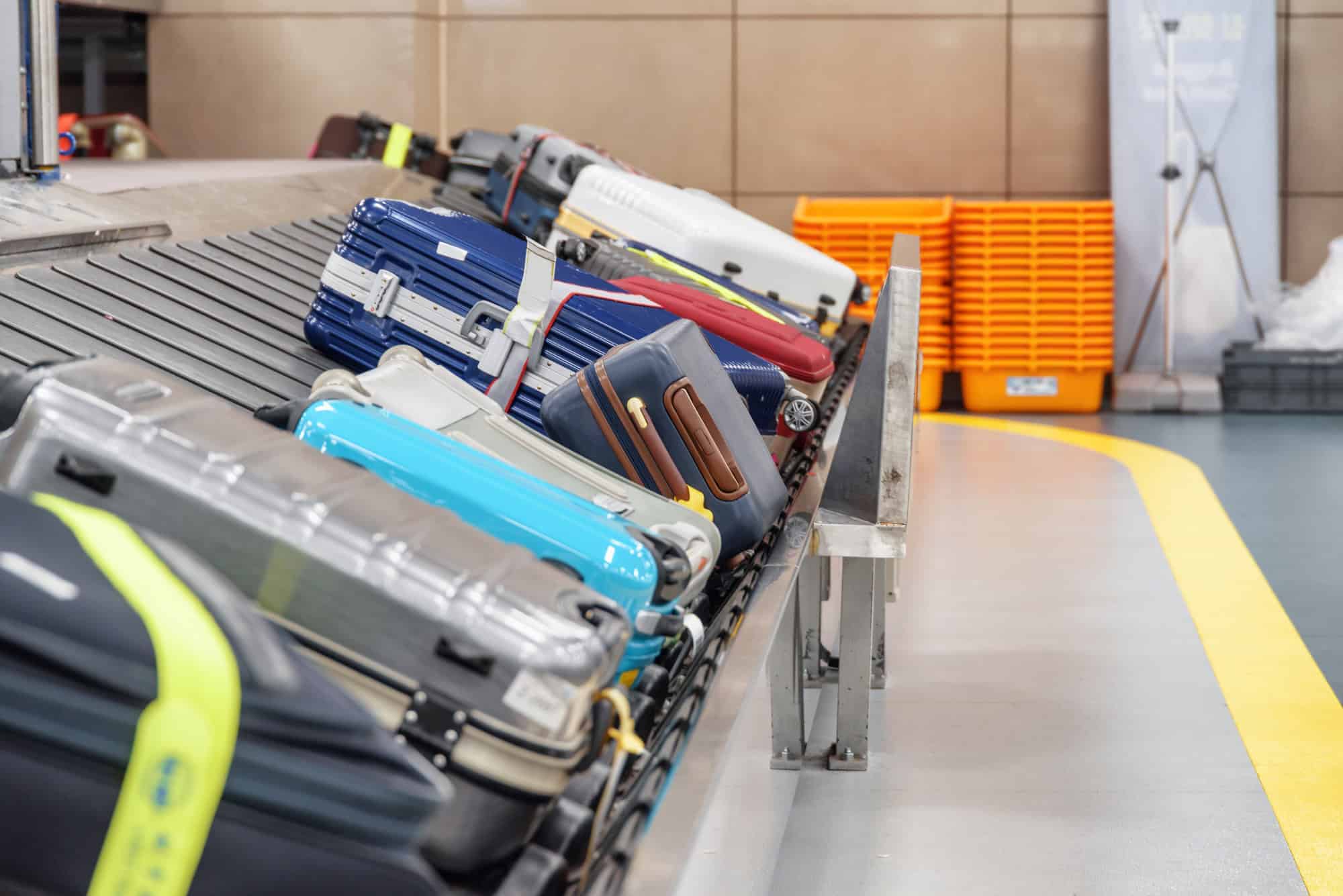 Suitcases on luggage conveyor belt in airport