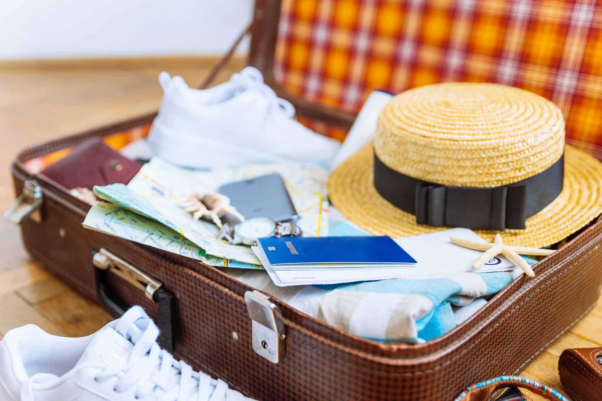 Woman's staff in a vsuitcase with travel documents