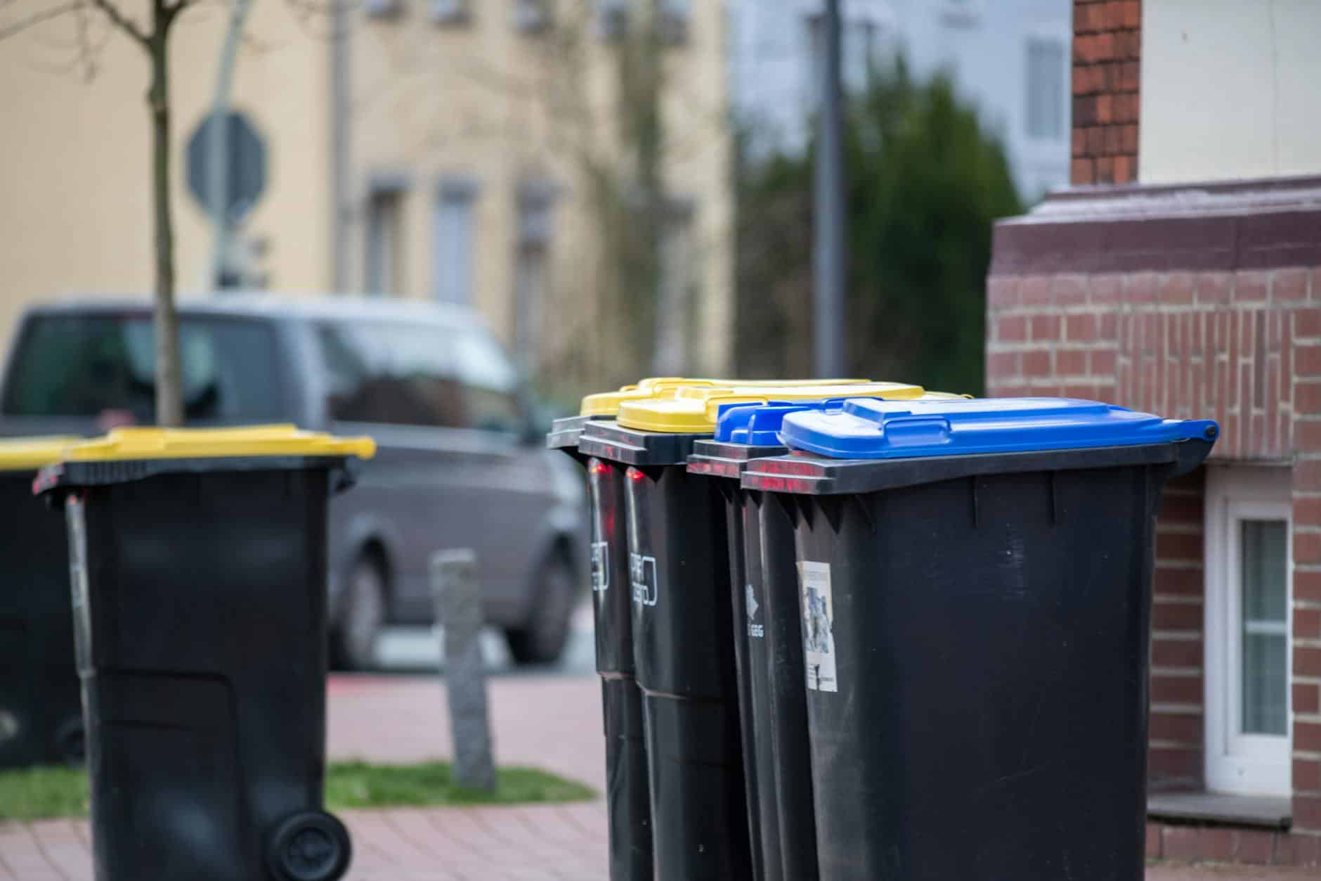 15 Road Trip Car Organizers for Traveling With Kids 4 Color-coded trash bins on a city street in Gütersloh, Germany, showcasing urban waste management.