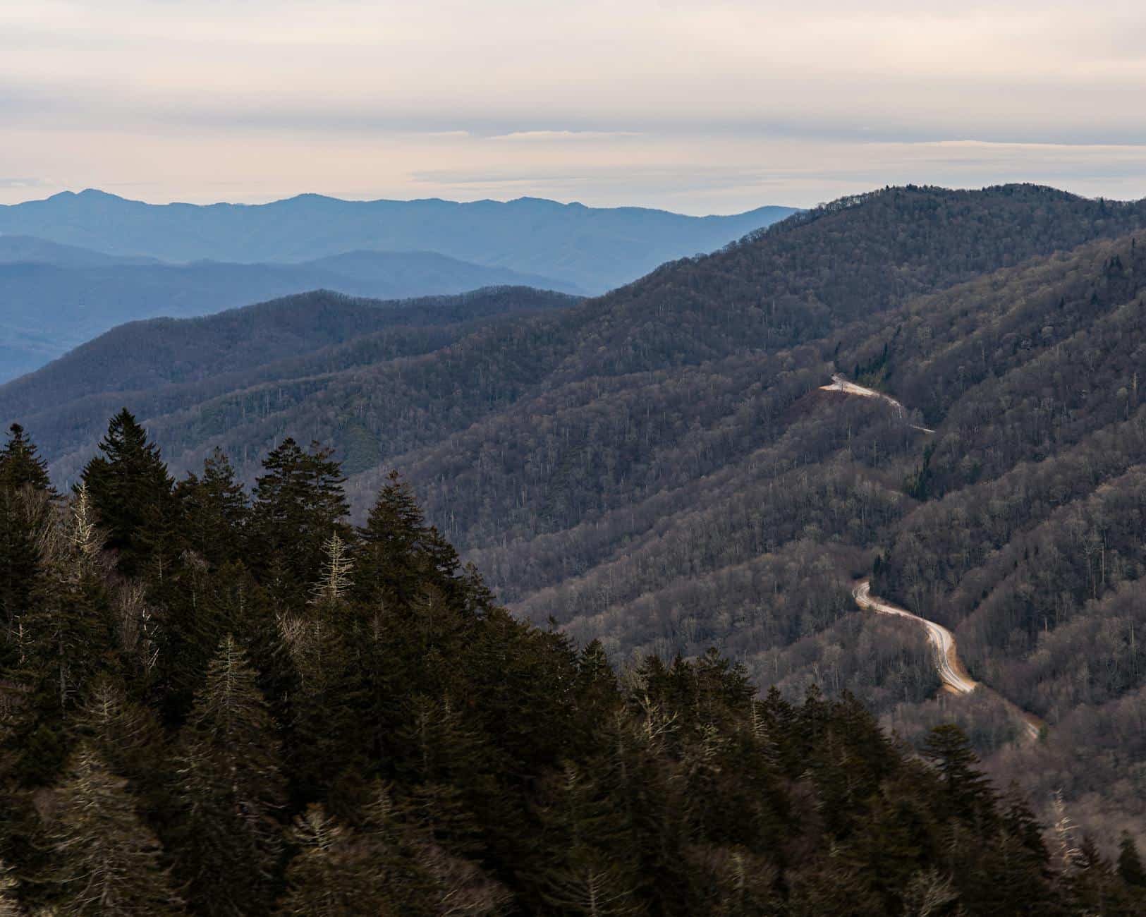 A captivating view of the Smoky Mountains with winding road, showcasing the serene winter landscape.