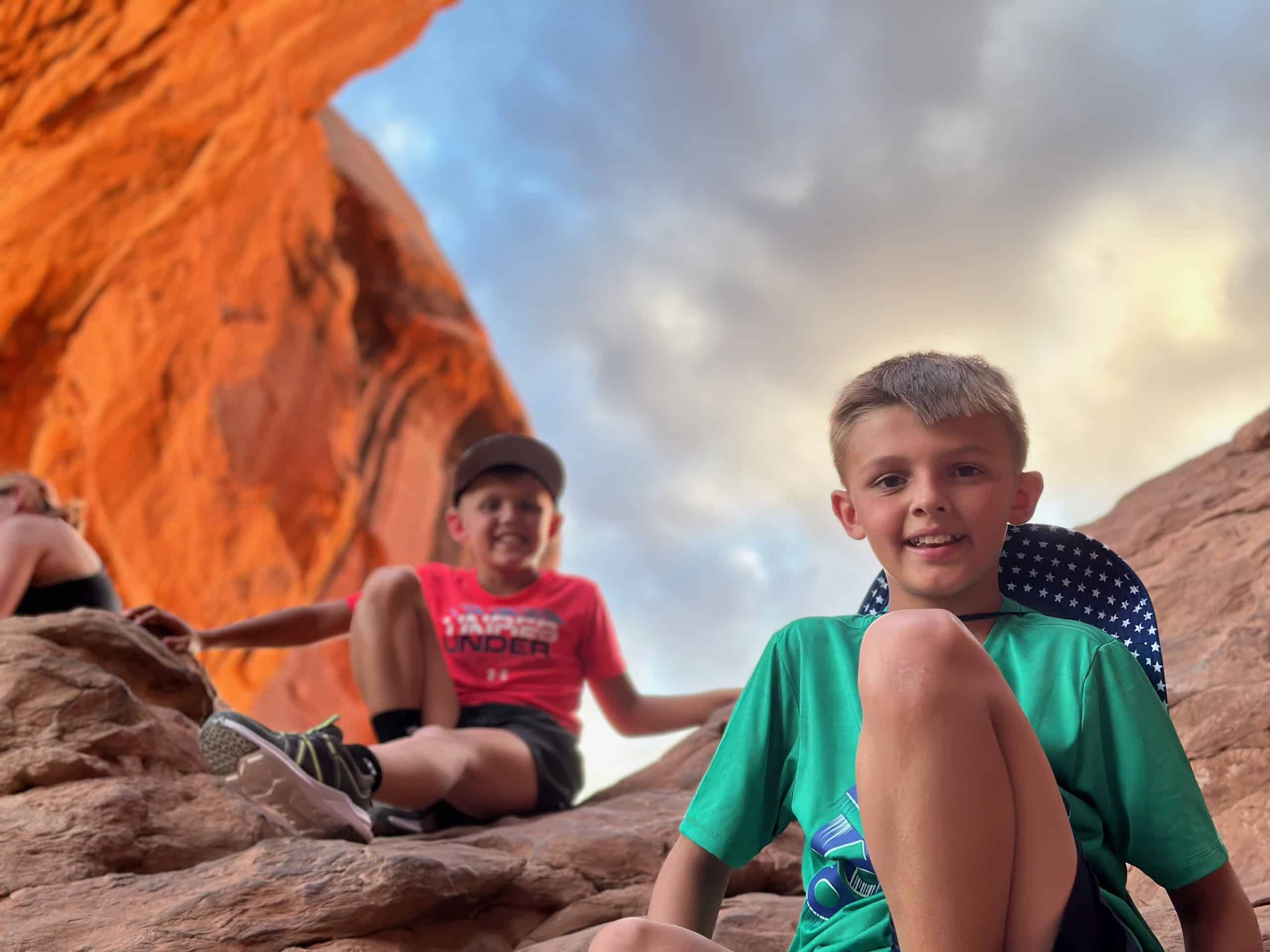 We’ve Been to Arches Five Times — Here’s Why We Never Get Tired of It 4 Two of our boys climbing into Double Arch at golden hour