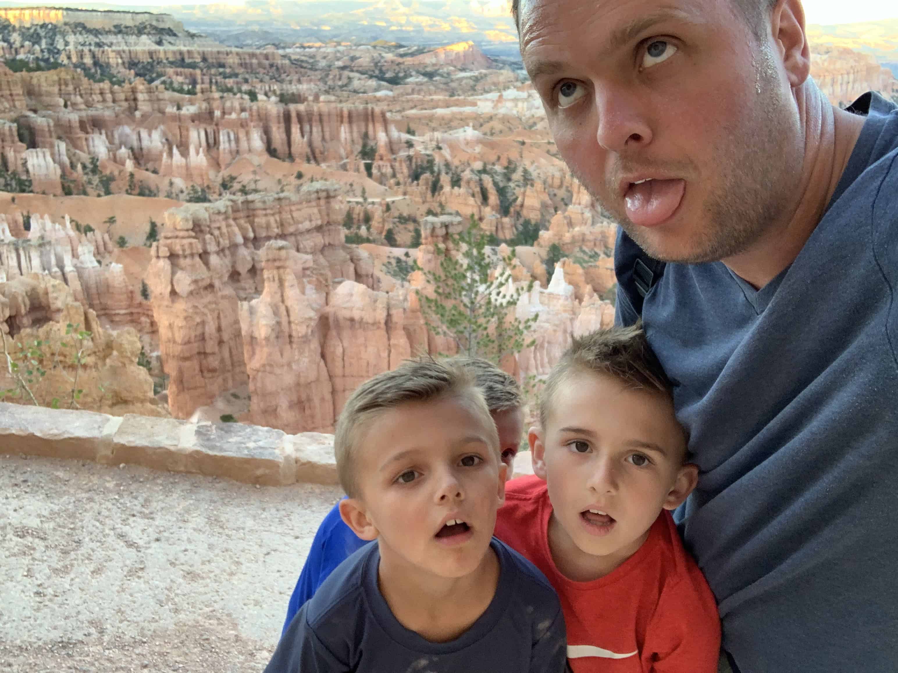 Bryce Canyon After Dark: The Most Underrated Mighty 5 Stop 1 Jake and the kids at a Bryce Canyon overlook with hoodoos behind them
