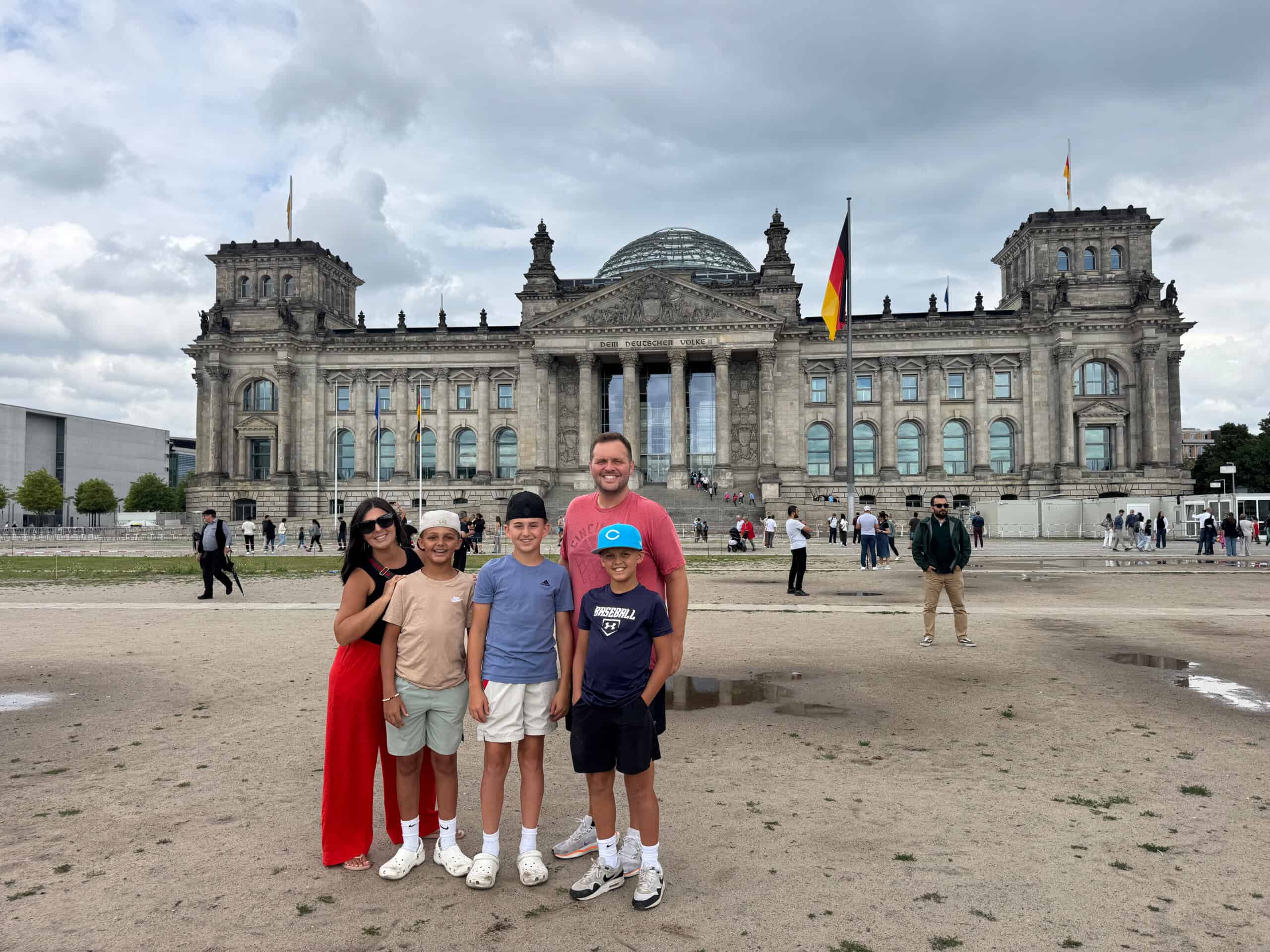 Five travelers posing in front of a historic building in Berlin