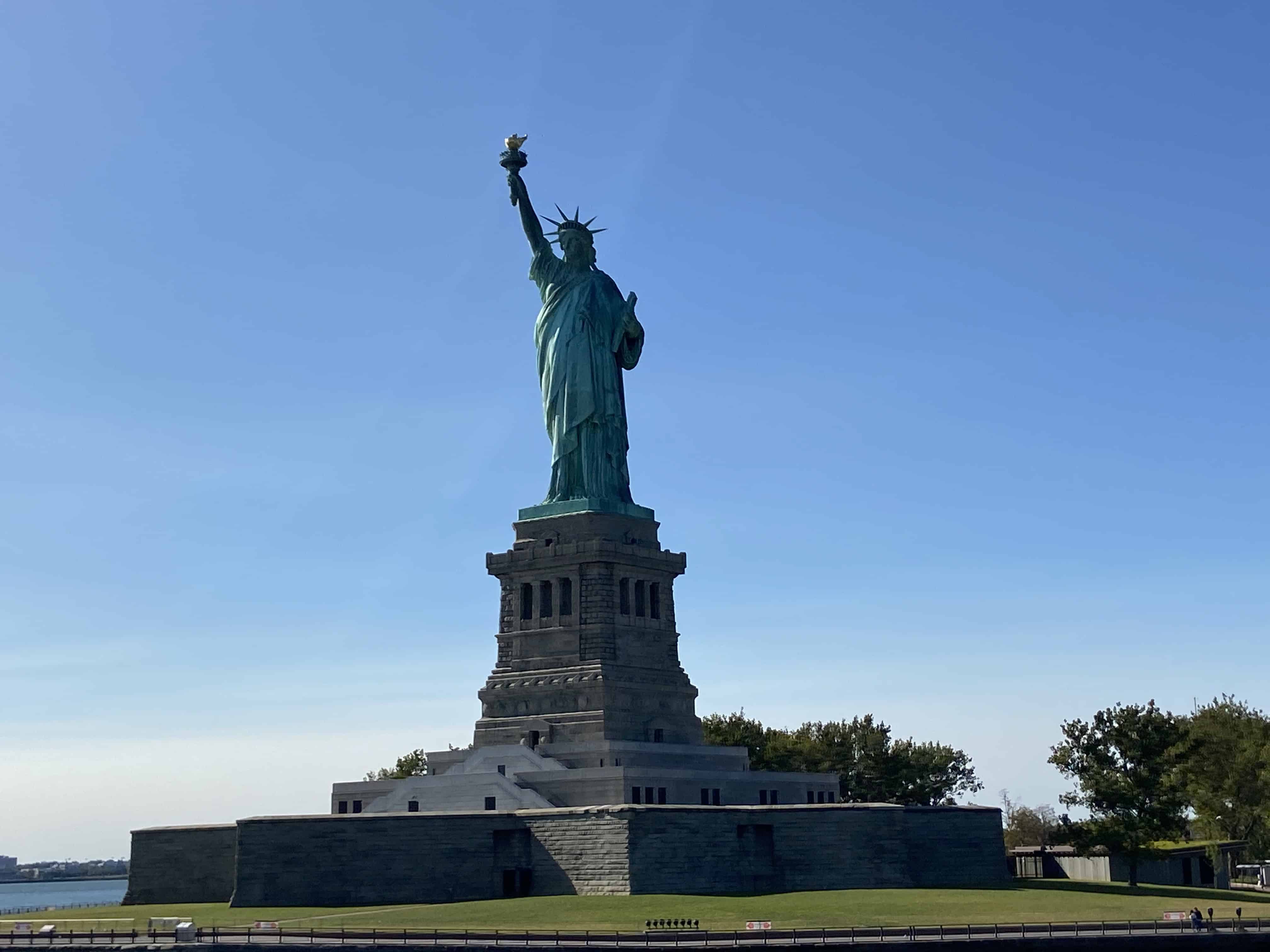 The Statue of Liberty beneath a clear blue sky.